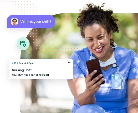Young nurse looking at phone outside